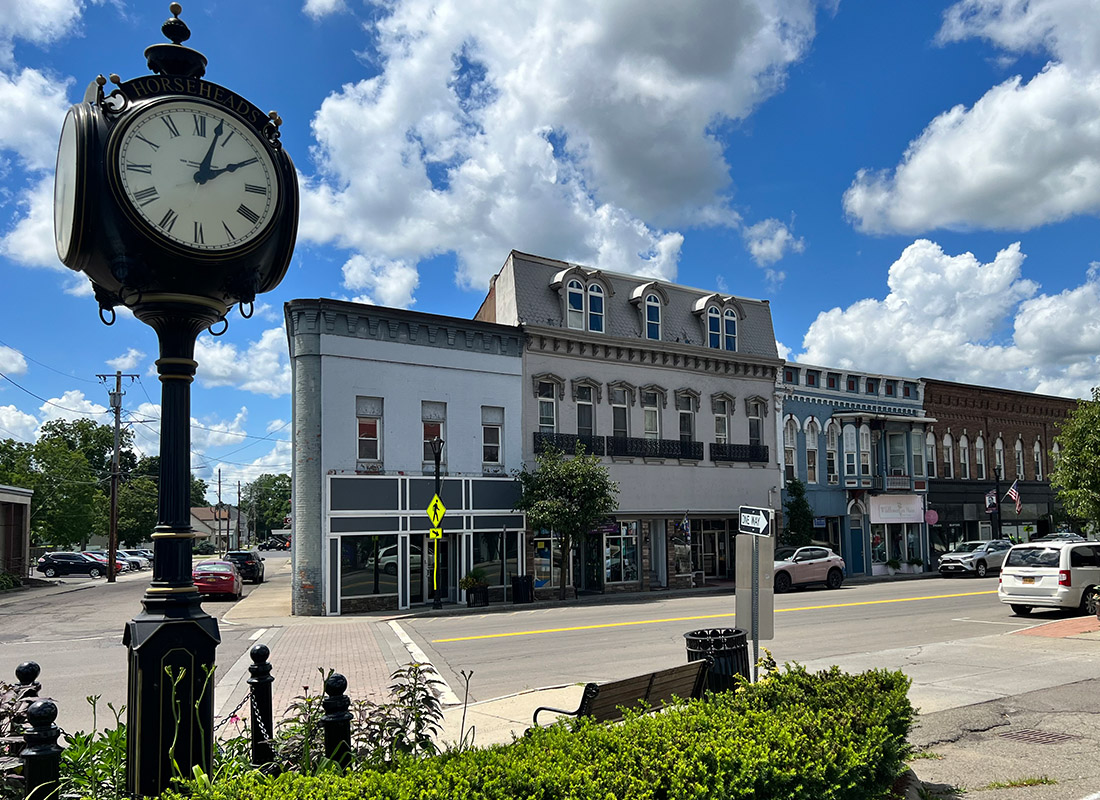 Contact - Small Town With Clock Tower on a Sunny Day